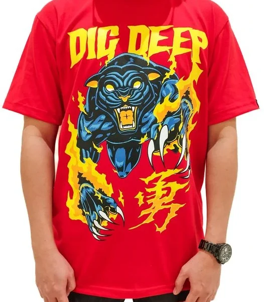 Male model wearing a red CLAW t-shirt, standing casually, showcasing the shirt design.