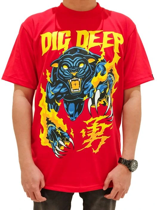 red-t-shirt-claws Male model wearing a red CLAW t-shirt, standing casually, showcasing the shirt design.