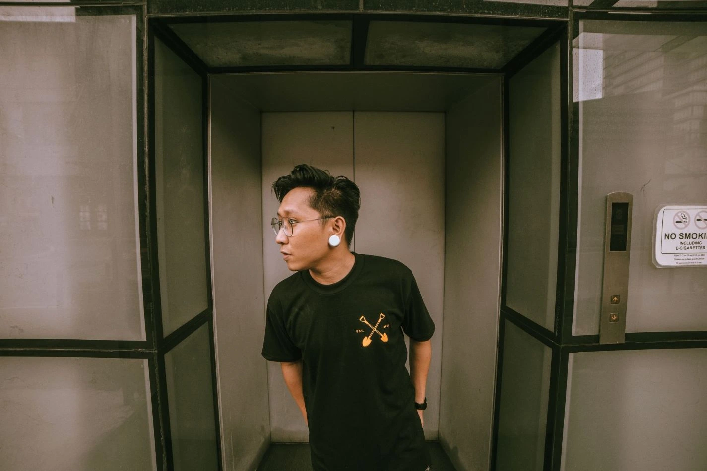 Side-view portrait of Jay C. wearing Sunset Camp.