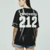 orchid-jersey-back-burn Female model in black Orchid Jersey back view, women’s athletic jersey design details.
