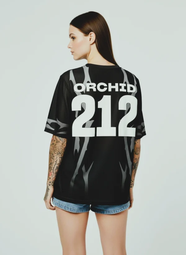 orchid-jersey-back-burn Female model in black Orchid Jersey back view, women’s athletic jersey design details.