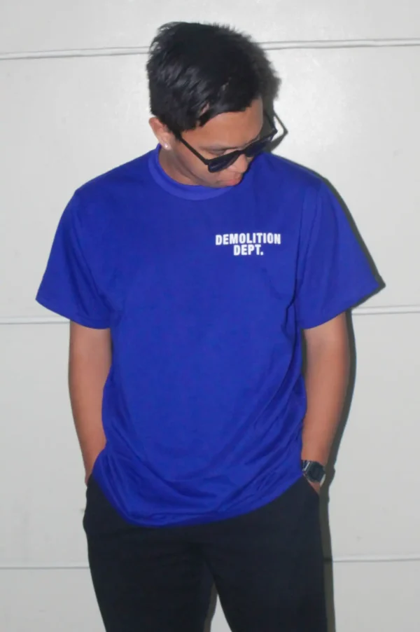 Male model wearing Demolition Dept. graphic T-shirt, front view.
