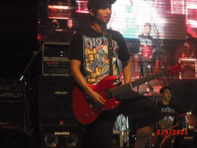 DIGGER MAN: THE FIRST DROP Ariel Lumanlan, Chicosci guitarist, wearing Dig Deep “Digger Man” shirt.